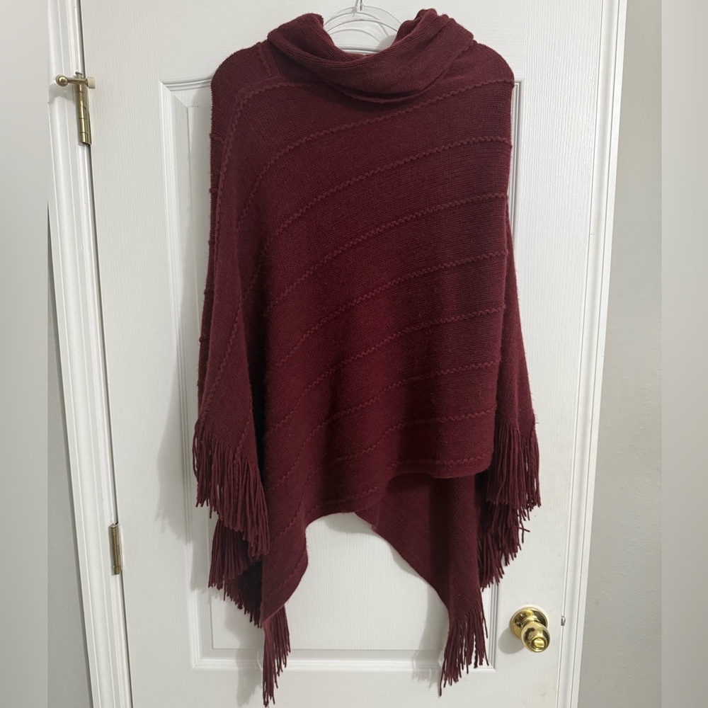 GUESS asymmetrical maroon turtleneck poncho with fringe detail